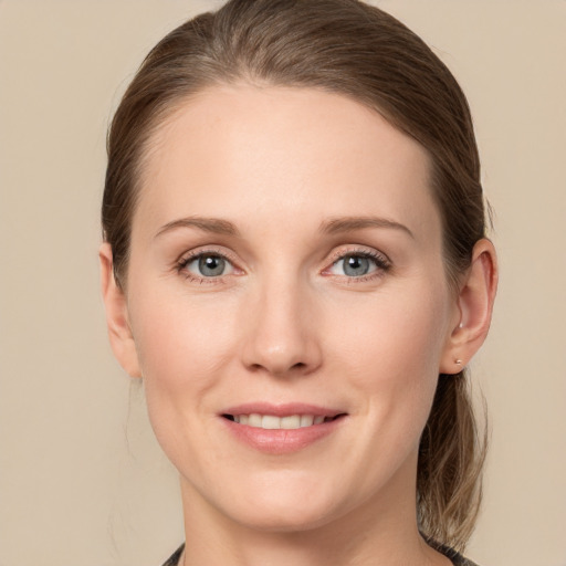 Joyful white young-adult female with medium  brown hair and grey eyes