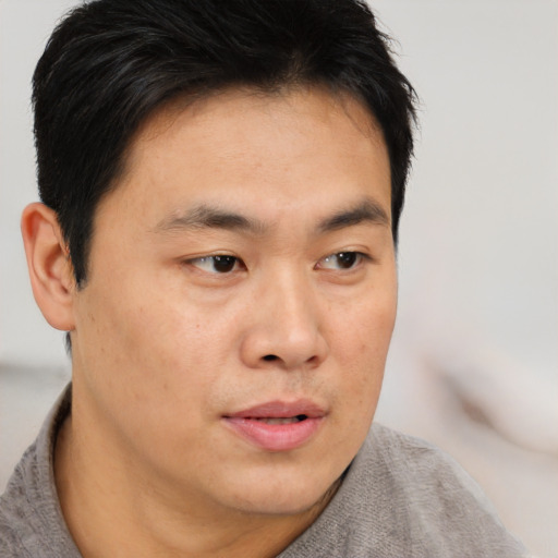 Neutral asian young-adult male with short  brown hair and brown eyes
