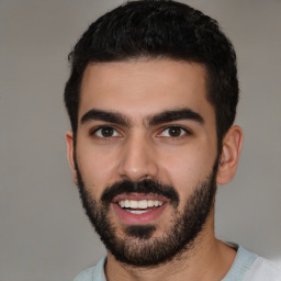 Joyful white young-adult male with short  black hair and brown eyes