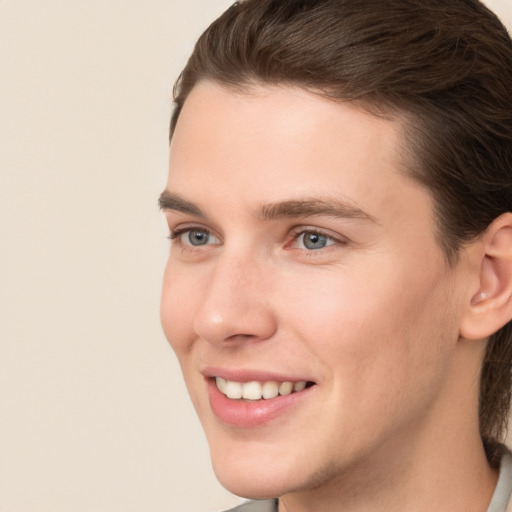 Joyful white young-adult male with medium  brown hair and brown eyes