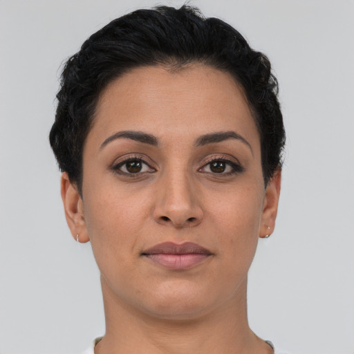 Joyful latino young-adult female with short  brown hair and brown eyes