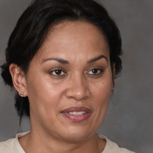 Joyful black adult female with short  brown hair and brown eyes