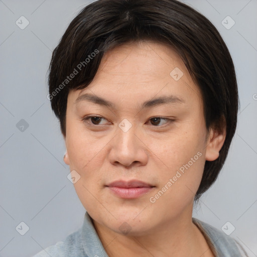 Joyful asian adult female with medium  brown hair and brown eyes