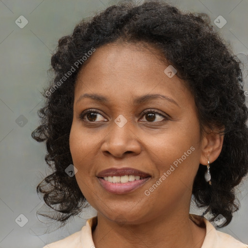 Joyful black adult female with medium  brown hair and brown eyes