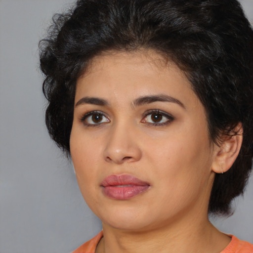 Joyful latino young-adult female with medium  black hair and brown eyes