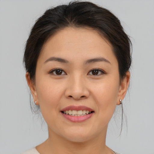 Joyful asian young-adult female with medium  brown hair and brown eyes