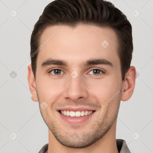 Joyful white young-adult male with short  brown hair and brown eyes