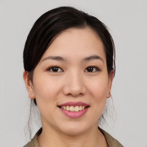Joyful asian young-adult female with medium  black hair and brown eyes