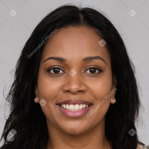 Joyful black young-adult female with long  brown hair and brown eyes