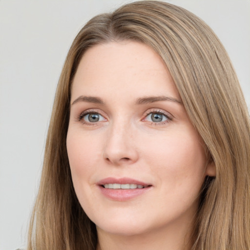 Joyful white young-adult female with long  brown hair and grey eyes