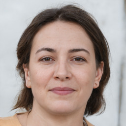 Joyful white adult female with medium  brown hair and brown eyes