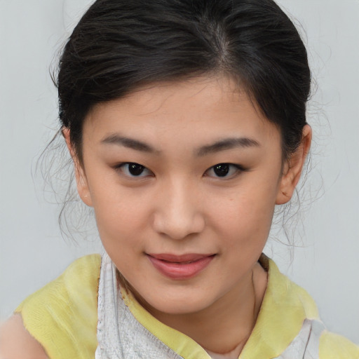 Joyful asian child female with medium  brown hair and brown eyes