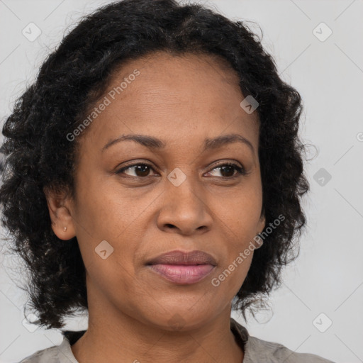 Joyful black adult female with medium  brown hair and brown eyes