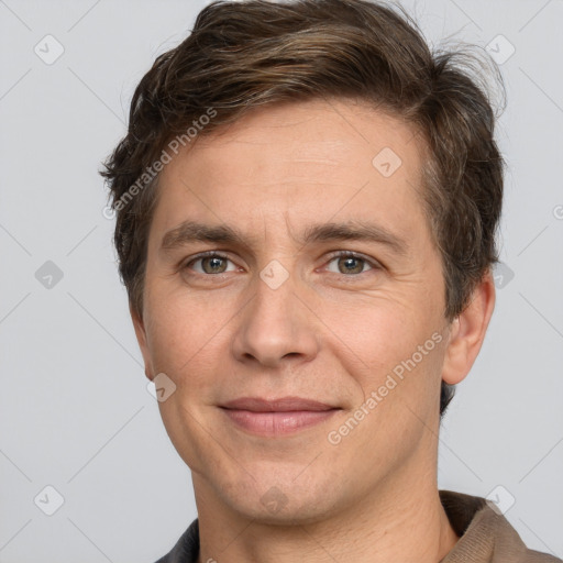 Joyful white adult male with short  brown hair and grey eyes