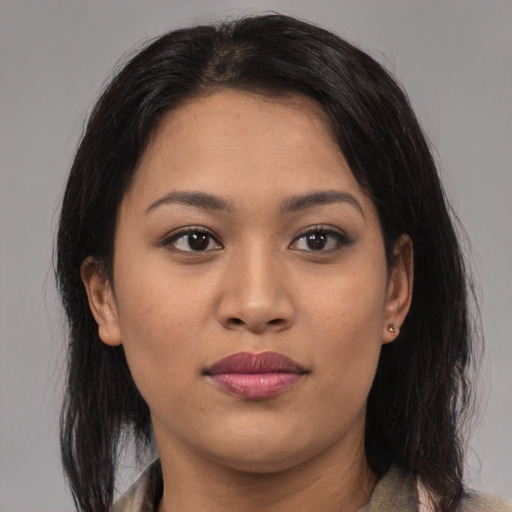 Joyful latino young-adult female with medium  brown hair and brown eyes