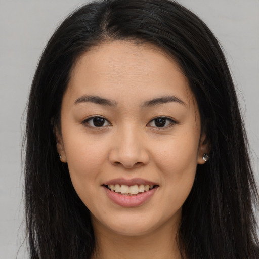 Joyful asian young-adult female with long  brown hair and brown eyes