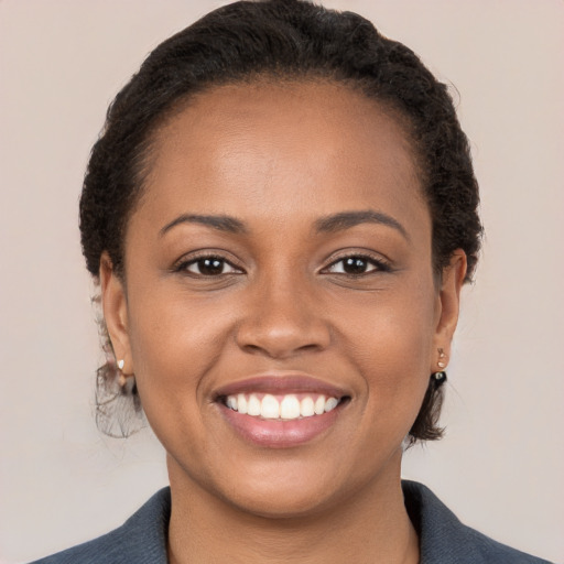 Joyful black young-adult female with medium  brown hair and brown eyes