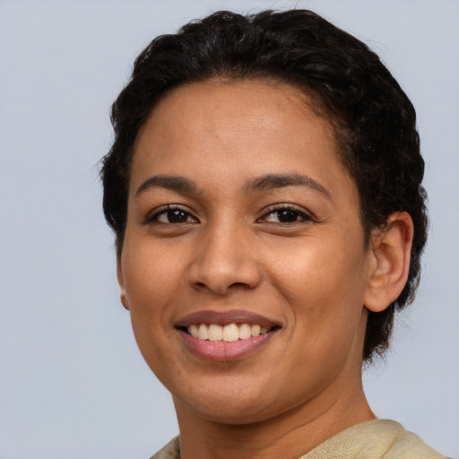 Joyful latino young-adult female with short  brown hair and brown eyes