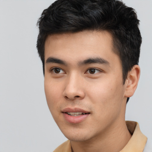 Joyful asian young-adult male with short  brown hair and brown eyes
