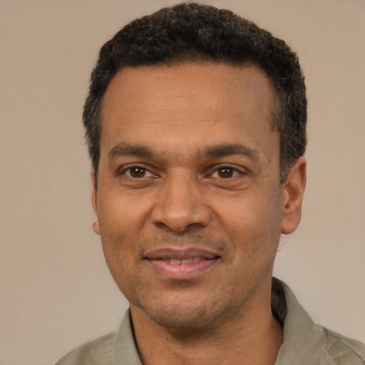 Joyful latino adult male with short  black hair and brown eyes