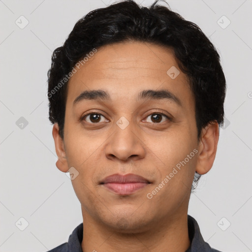 Joyful latino young-adult male with short  brown hair and brown eyes