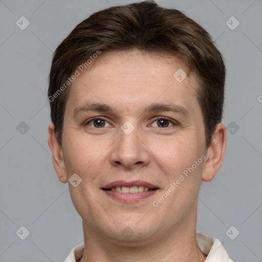 Joyful white young-adult male with short  brown hair and grey eyes