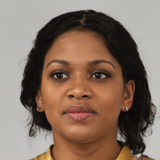 Joyful black young-adult female with medium  black hair and brown eyes
