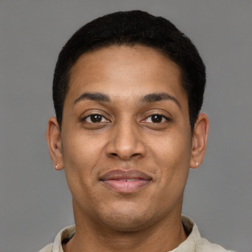 Joyful latino young-adult male with short  brown hair and brown eyes