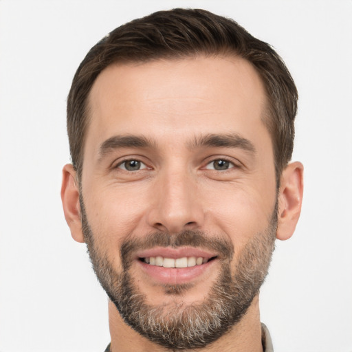 Joyful white young-adult male with short  brown hair and brown eyes