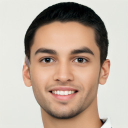 Joyful latino young-adult male with short  black hair and brown eyes