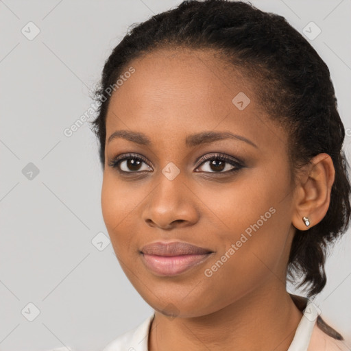 Joyful black young-adult female with long  brown hair and brown eyes