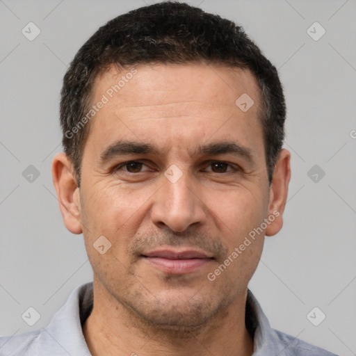 Joyful white adult male with short  brown hair and brown eyes