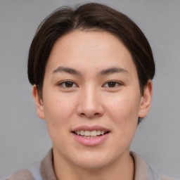 Joyful asian young-adult female with short  brown hair and brown eyes