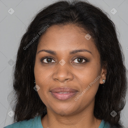 Joyful black young-adult female with long  brown hair and brown eyes