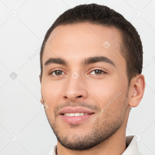 Joyful white young-adult male with short  black hair and brown eyes