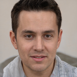 Joyful white adult male with short  brown hair and brown eyes