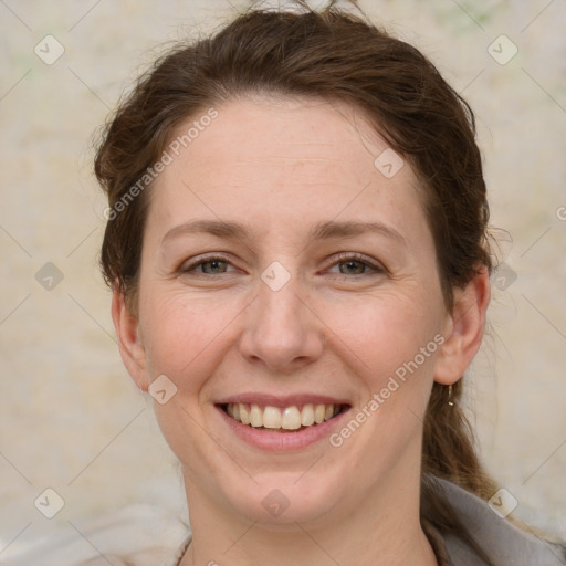 Joyful white adult female with medium  brown hair and grey eyes