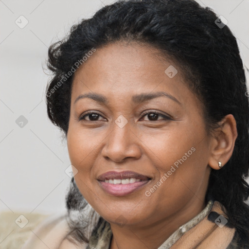 Joyful black adult female with long  brown hair and brown eyes