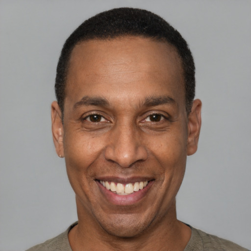Joyful latino adult male with short  black hair and brown eyes