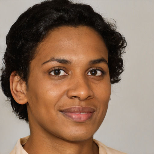 Joyful black young-adult female with short  brown hair and brown eyes