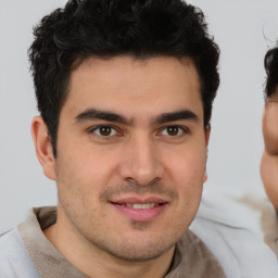 Joyful latino young-adult male with short  brown hair and brown eyes