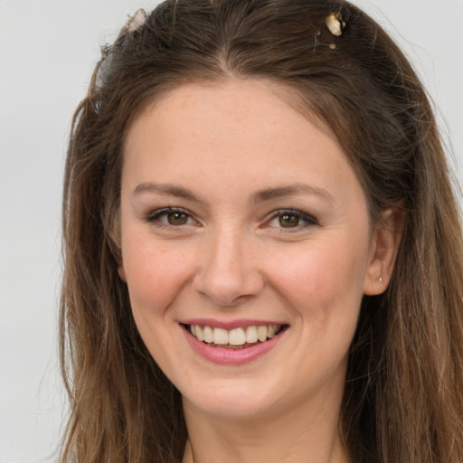 Joyful white young-adult female with long  brown hair and brown eyes