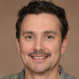 Joyful white adult male with short  brown hair and brown eyes