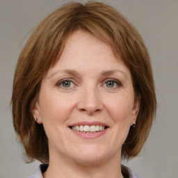 Joyful white adult female with medium  brown hair and grey eyes