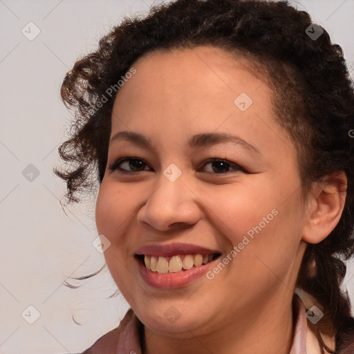 Joyful black young-adult female with medium  brown hair and brown eyes