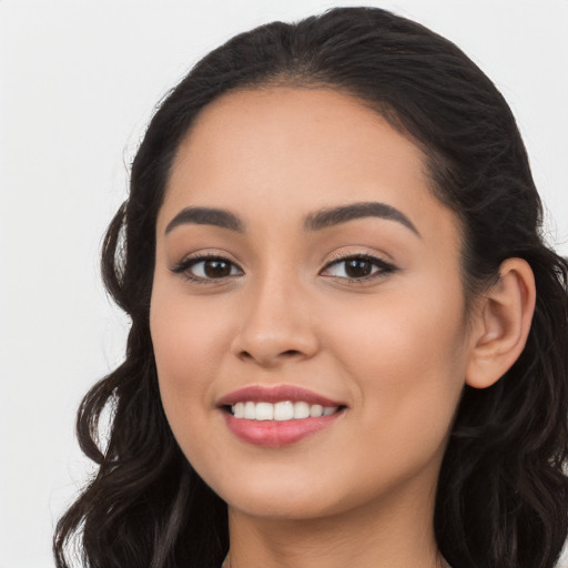 Joyful latino young-adult female with long  black hair and brown eyes