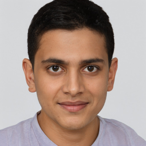Joyful latino young-adult male with short  brown hair and brown eyes
