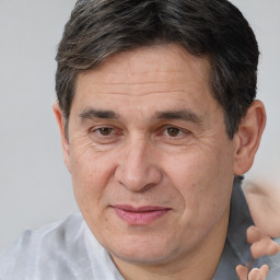 Joyful white middle-aged male with short  brown hair and brown eyes