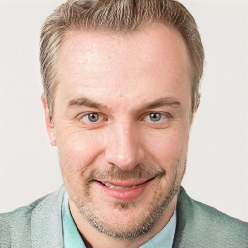 Joyful white adult male with short  brown hair and blue eyes