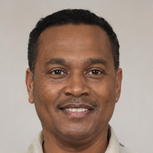 Joyful black adult male with short  brown hair and brown eyes